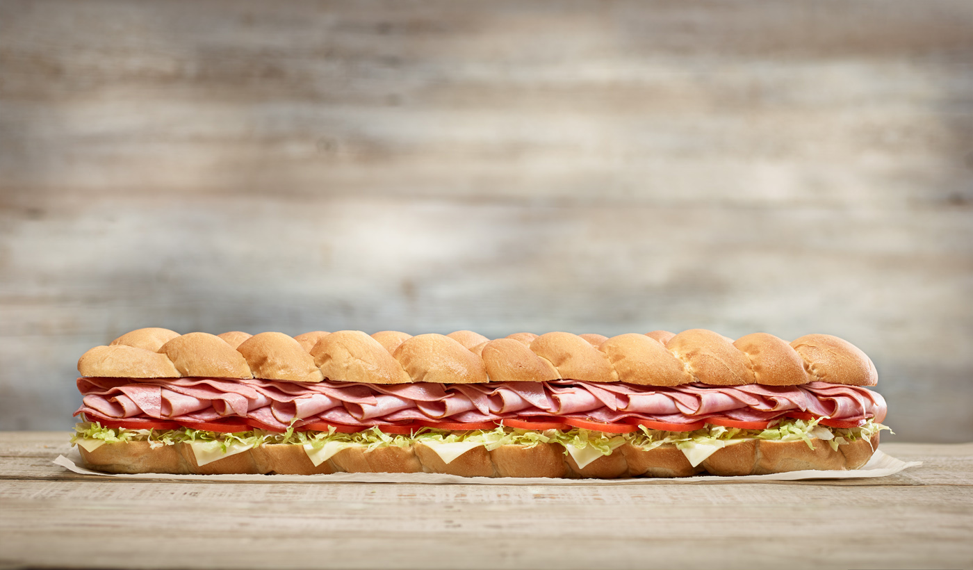 Mr.sub party sub massive sandwich 2 feet long with ham tomatoes lettuce cheese in bread