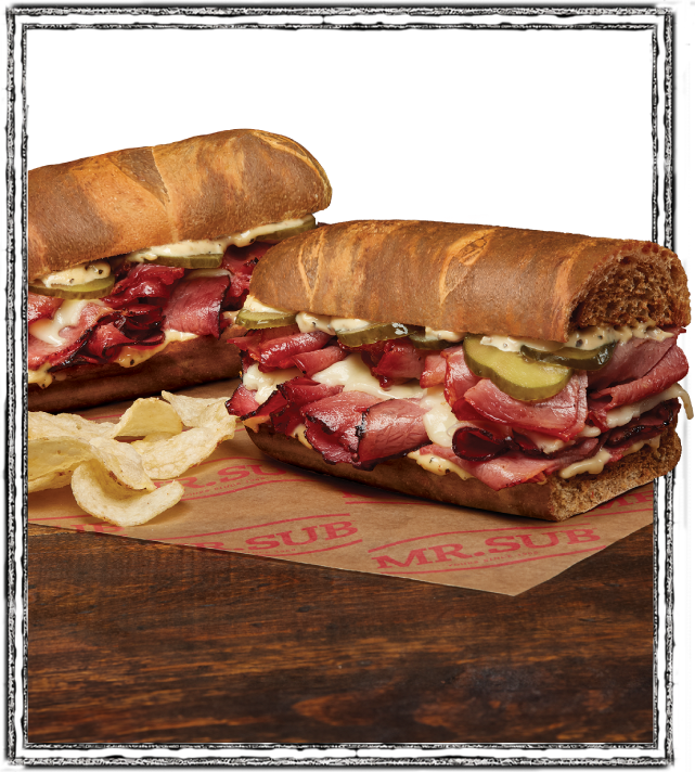 marble rye double stack sandwich on table with chips